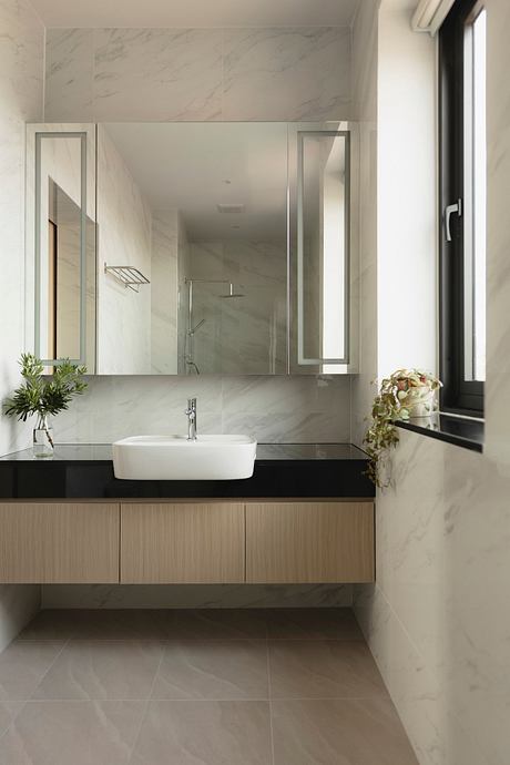 Elegant bathroom design featuring a modern vanity, vessel sink, and large mirrors.