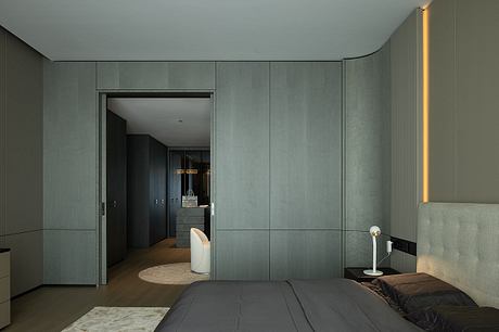 Sleek, modern bedroom with built-in gray cabinetry, indirect lighting, and minimalist decor.