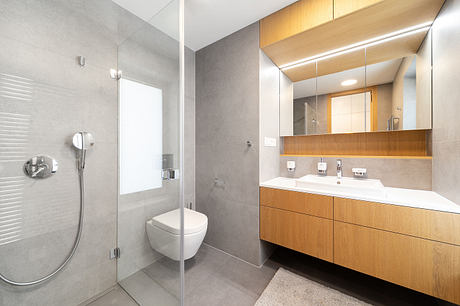Sleek, modern bathroom design featuring clean lines, wood cabinetry, and minimalist fixtures.