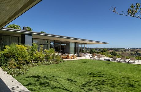 Casa Fluir is a L-Shaped House Designed Around a Shared Central Courtyard