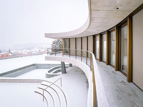 Winkelhaus — Curved Family Home Rooted in Swiss Hillside Landscape - 6