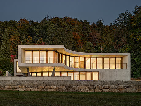 Winkelhaus — Curved Family Home Rooted in Swiss Hillside Landscape - 8