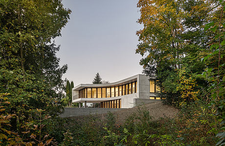 Winkelhaus — Curved Family Home Rooted in Swiss Hillside Landscape