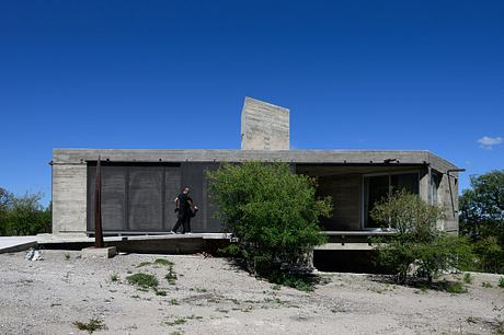Casa Cosmos: Rammed Stone and Exposed Concrete on a Sloped Site Edge - 1