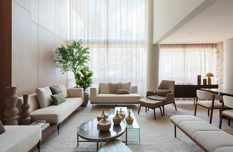 Cerâmica Apartment Shapes Calm Interiors Through Warm Stone and Wood