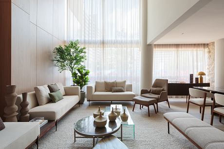 Cerâmica Apartment Shapes Calm Interiors Through Warm Stone and Wood - 1