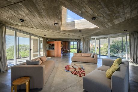 Casa Cosmos: Rammed Stone and Exposed Concrete on a Sloped Site Edge - 2