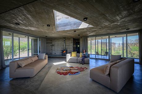 Casa Cosmos: Rammed Stone and Exposed Concrete on a Sloped Site Edge - 3