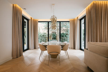 Pigwy Residence Shapes a Quiet Domestic Mood Through Marble and Oak - 2