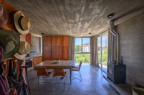 Casa Cosmos: Rammed Stone and Exposed Concrete on a Sloped Site Edge - 6