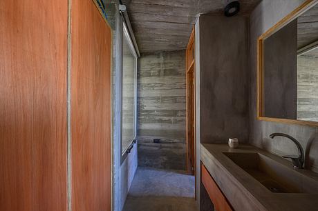 Casa Cosmos: Rammed Stone and Exposed Concrete on a Sloped Site Edge - 8
