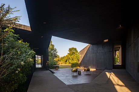 Casa Mavra Turns Two Angular Volumes into a Black Concrete House - 4