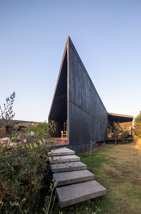Casa Mavra Turns Two Angular Volumes into a Black Concrete House - 7